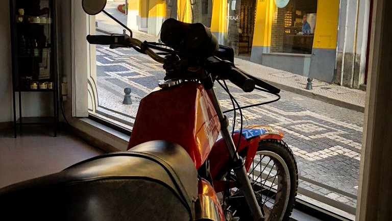 Moto vintage na entrada da Clandestina